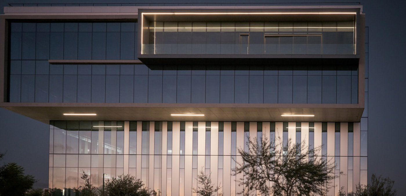 Modern commercial building illuminated at dusk